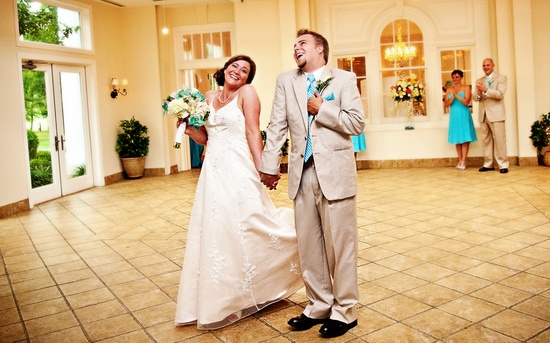 Happy bride and groom at wedding reception laughing