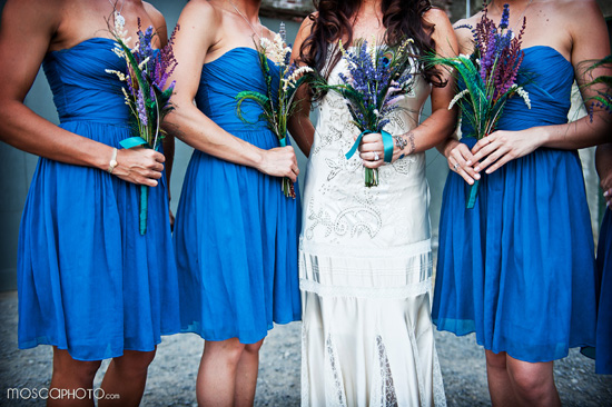 Bridesmaids in blue dresses at outdoor wedding scene