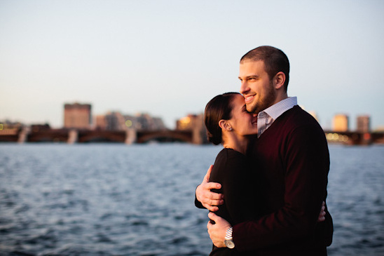 Romantic couple embracing by the water at sunset