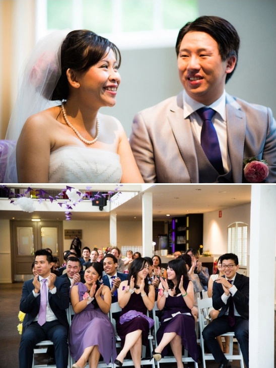 Happy couple at their wedding with guests clapping