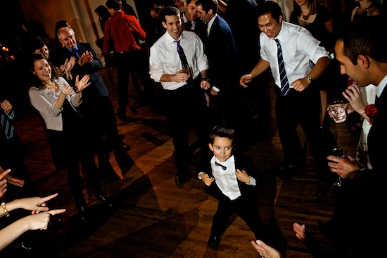Boy in tuxedo dances at wedding reception party