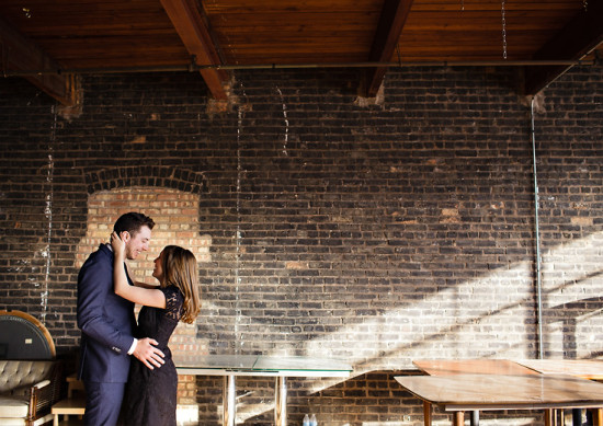 Romantic couple share moment brick wall