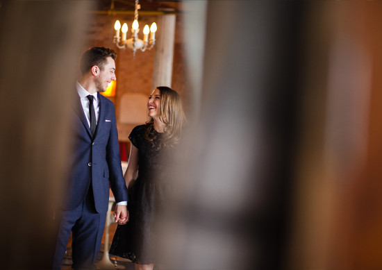 Happy couple holding hands smiling lovingly indoors