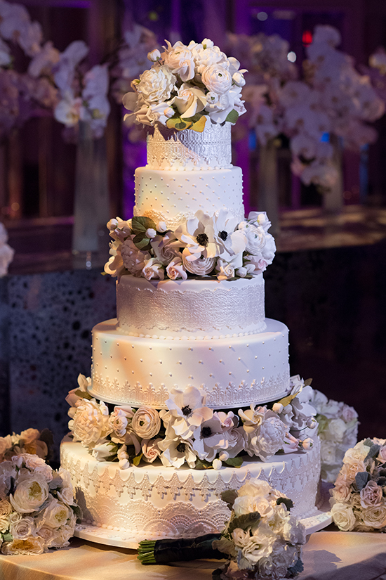 Elegant five tier white wedding cake with floral decorations