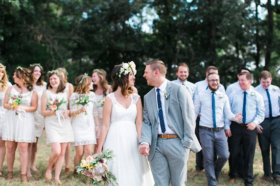 Bride and groom with wedding party smiling at each other