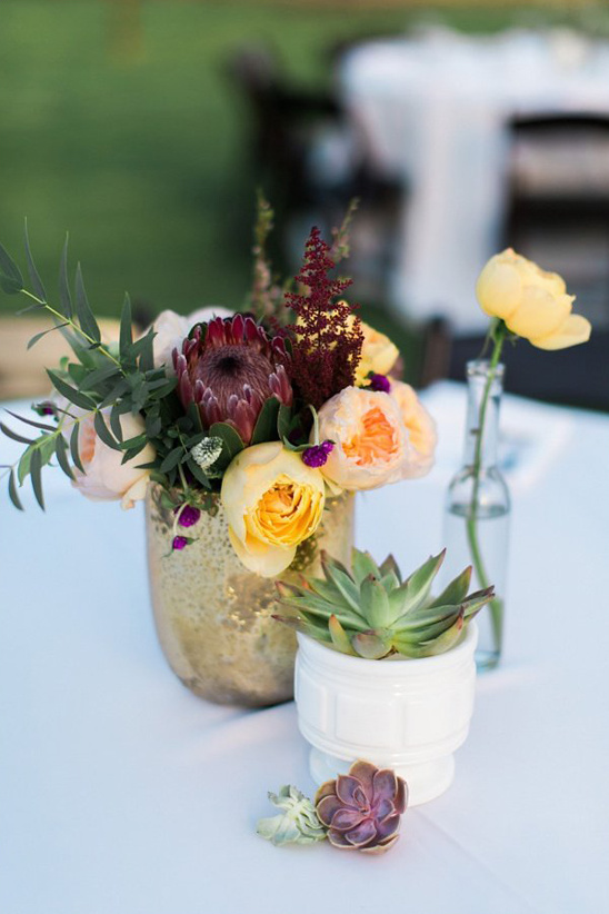Elegant floral arrangement with succulent and yellow flower on table