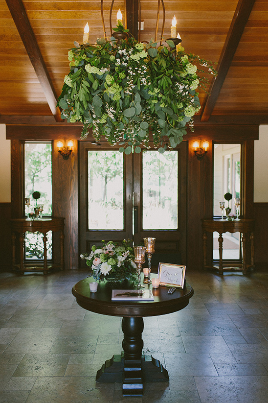 Elegant floral chandelier and guest book table interior