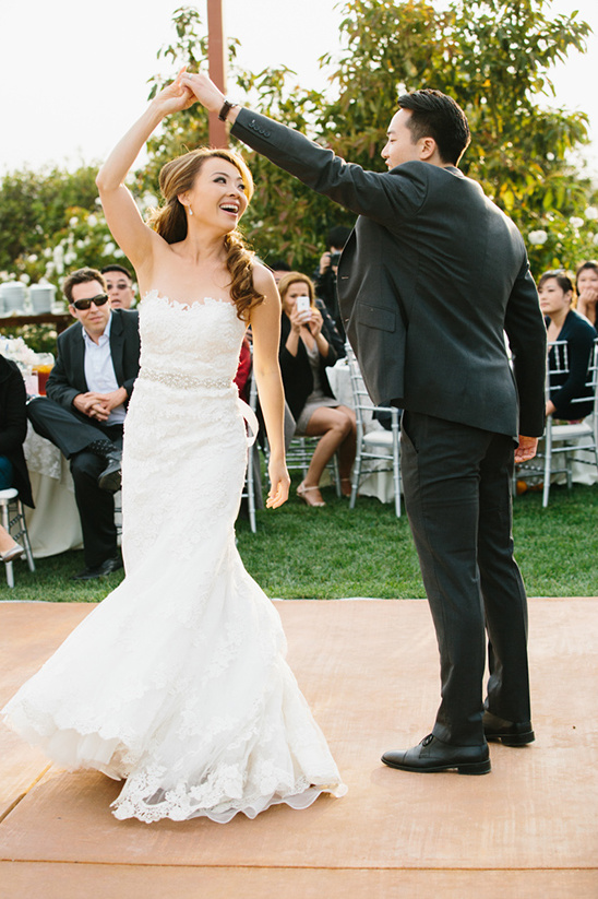 Bride and groom share first dance at outdoor wedding