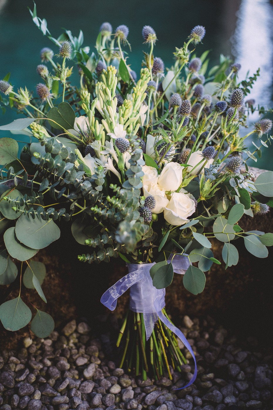 Elegant wedding bouquet with white roses and blue thistle