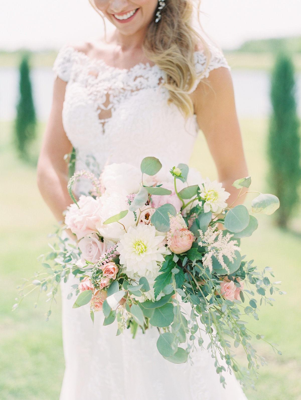 Bride holding beautiful blush pink wedding bouquet