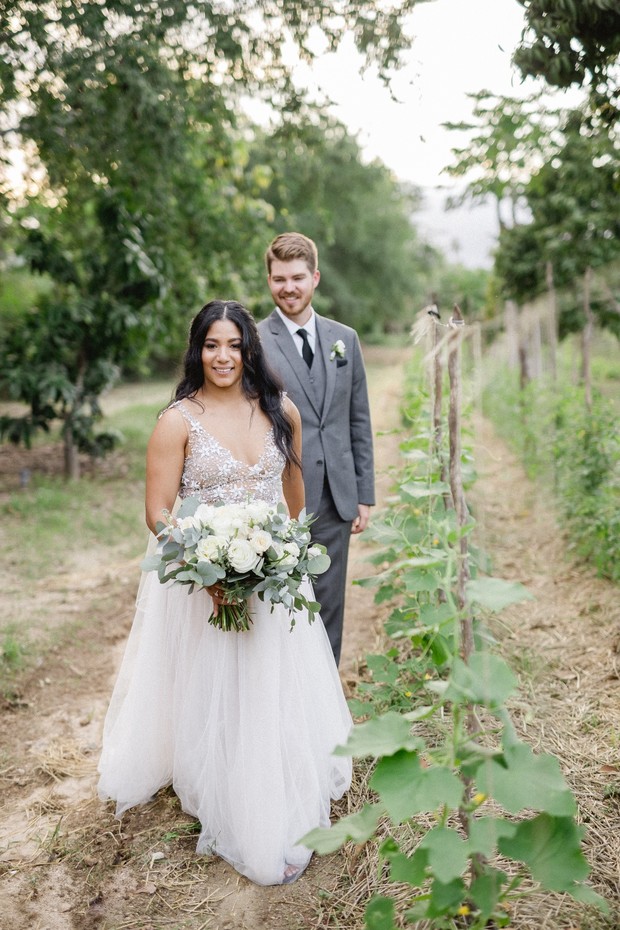 Bride and groom smiling on wedding day outdoor