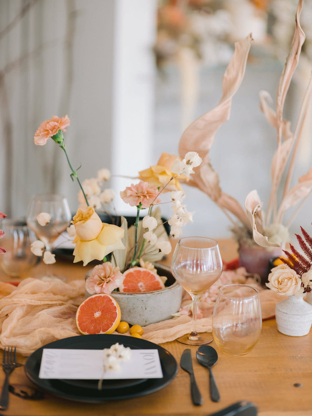 Elegant table setting with grapefruit and floral centerpiece