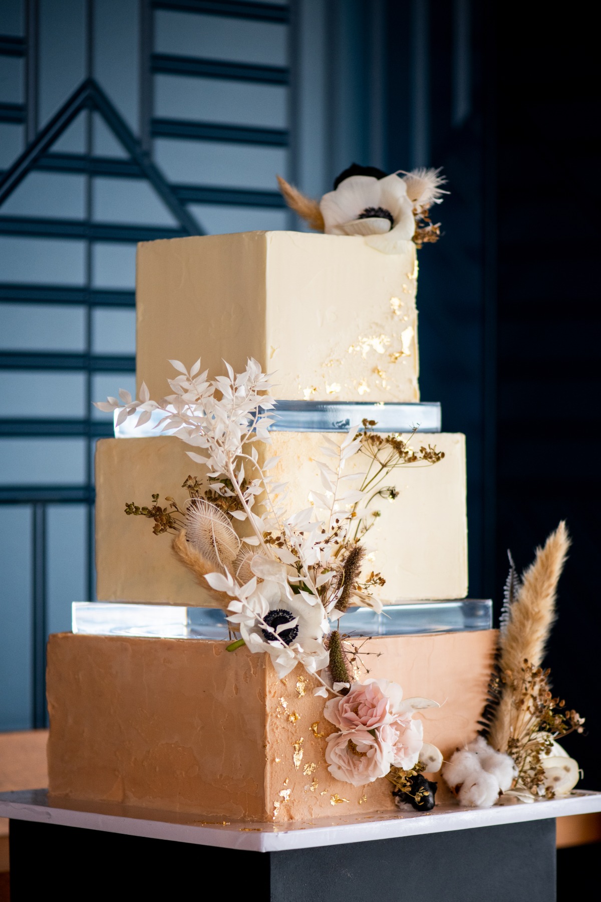 Elegant square tiered wedding cake with floral decoration