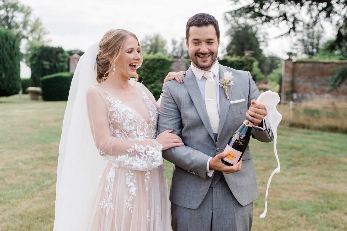 Happy bride and groom celebrate with champagne on their wedding day