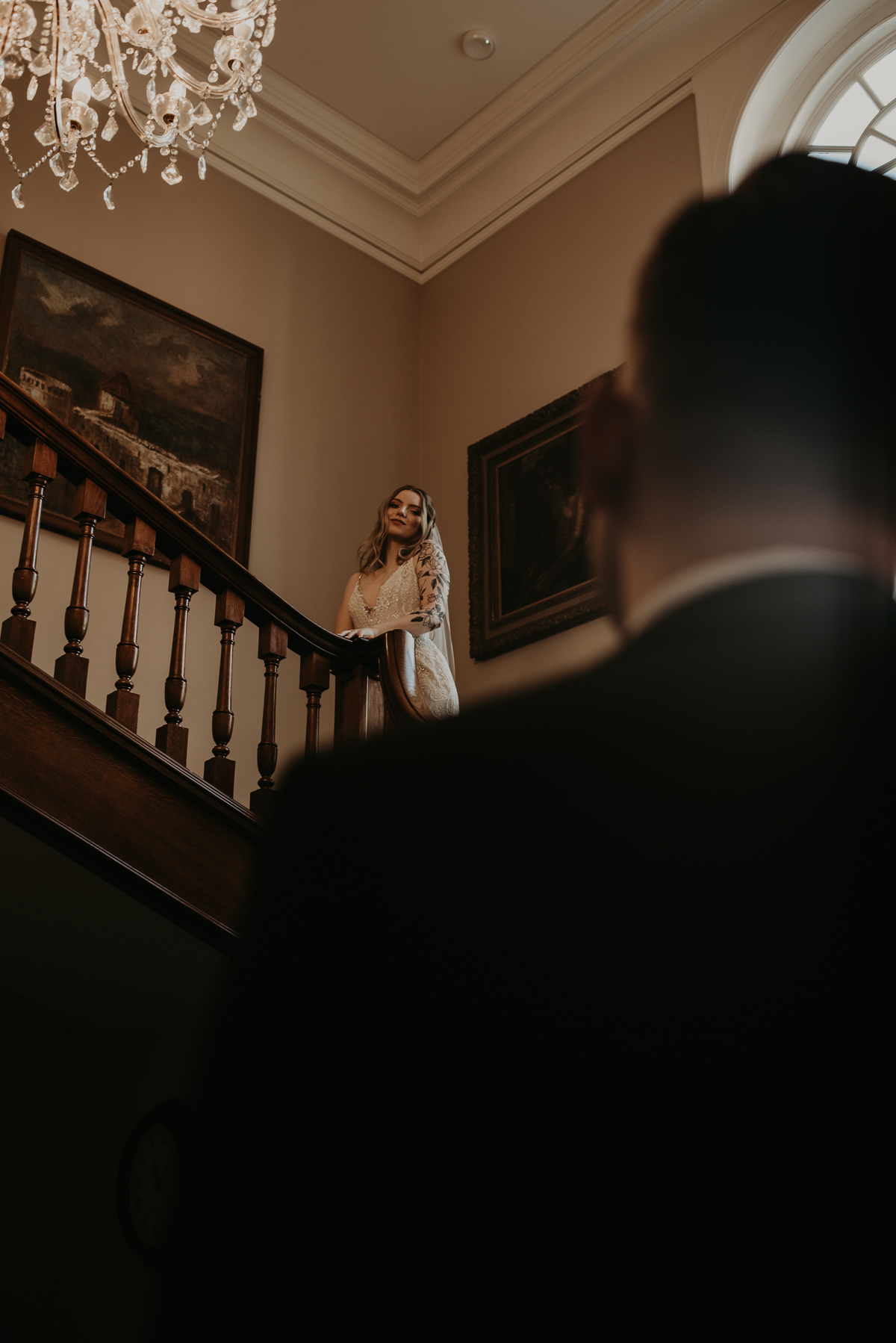 Bride awaits groom on elegant staircase wedding portrait