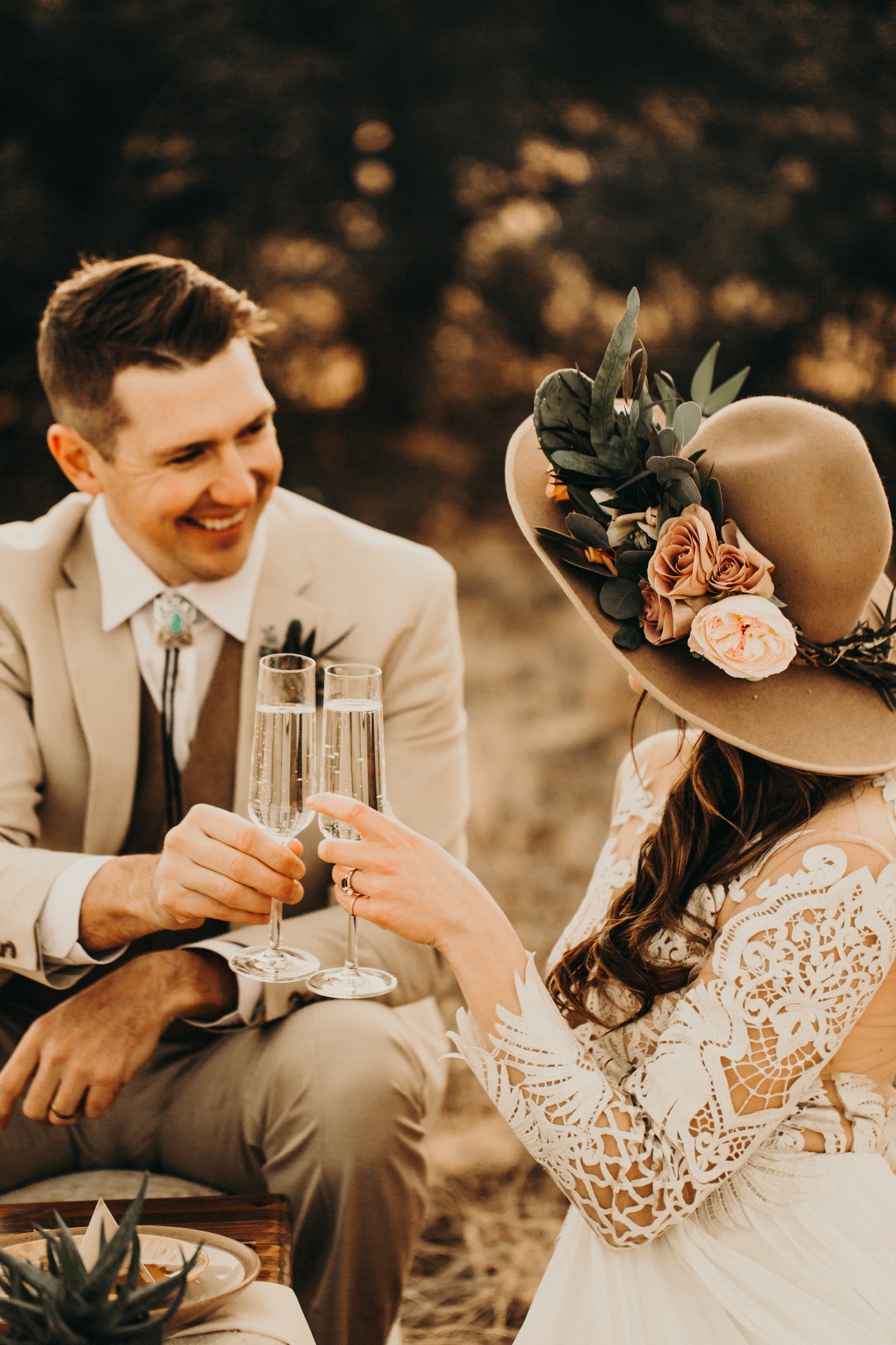 Bride and groom toasting with champagne outdoors