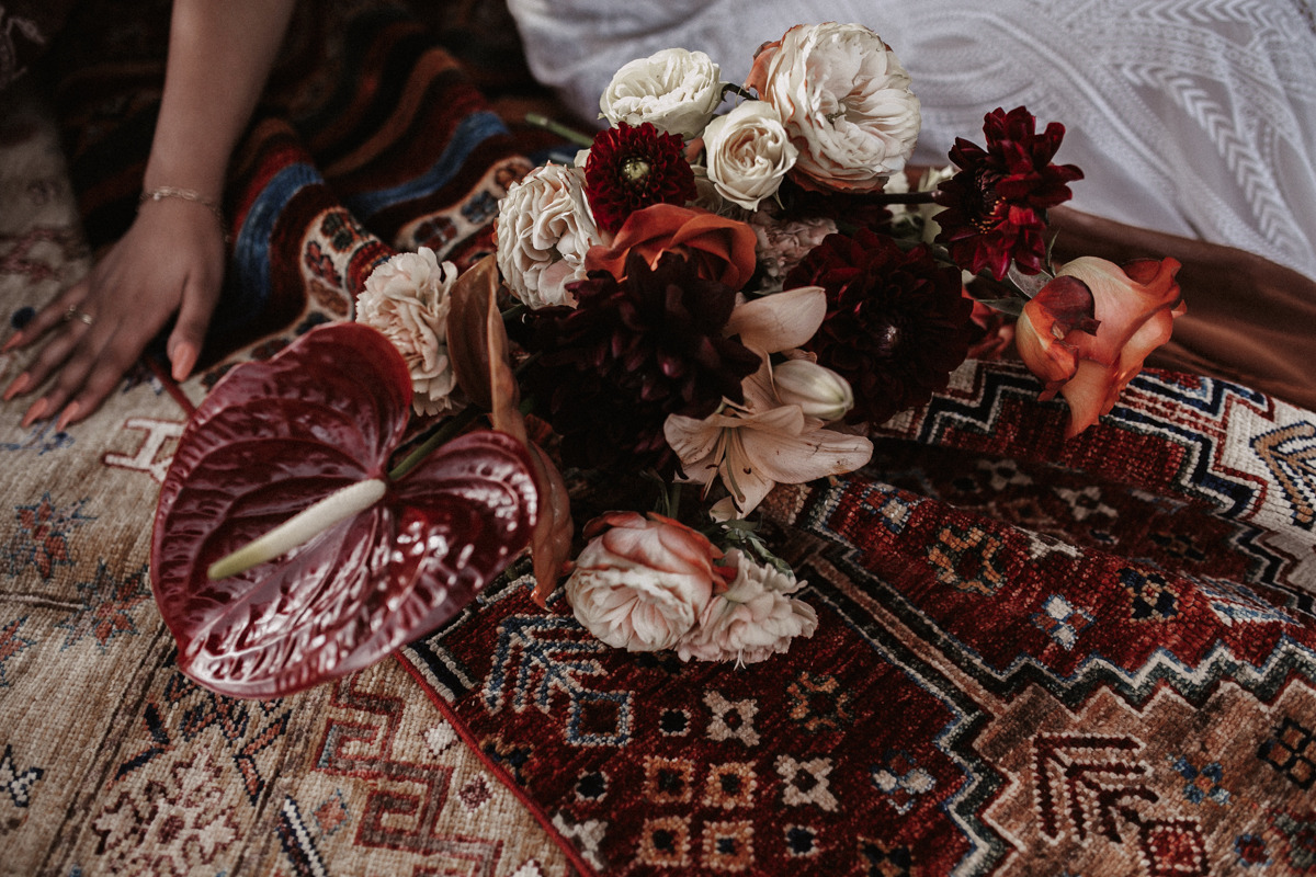 Dark red flowers on patterned rug