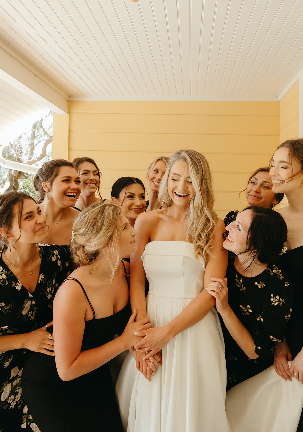 Joyful bride and bridesmaids celebrate wedding day