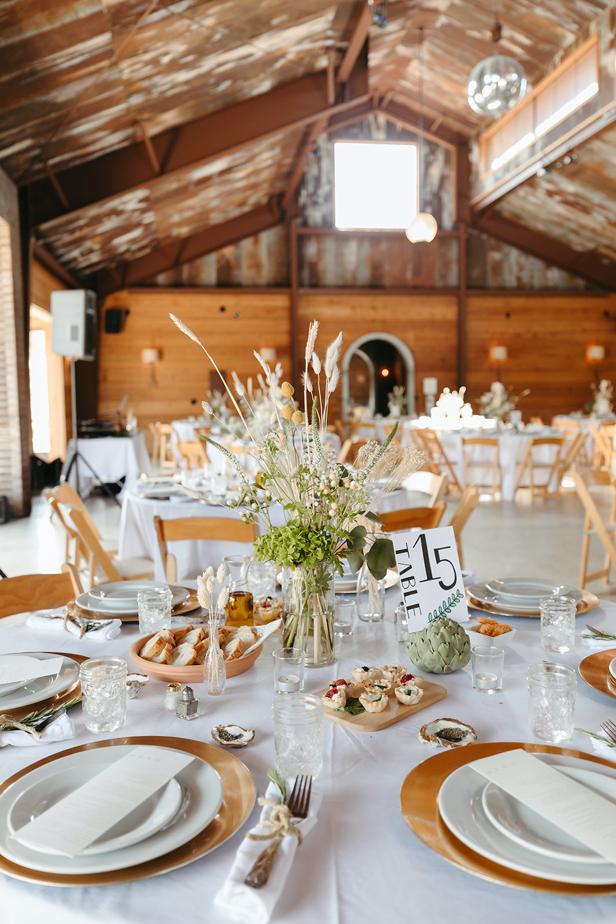 Beautiful rustic barn wedding reception table setup