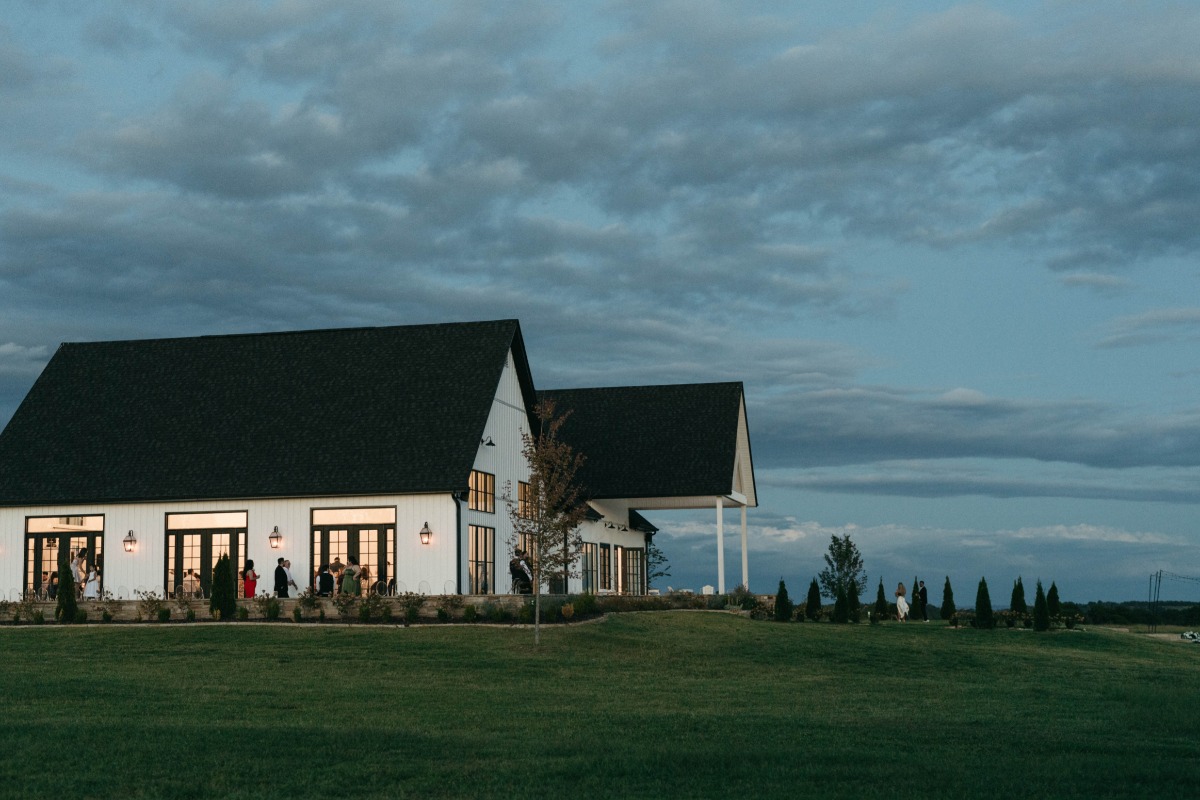 black and white vineyard barn wedding venue with moody sky